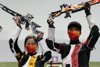 Yang Qian, left, and Yang Haoran, of China, celebrate after taking the gold medal in the mixed team 10-meter air rifle at the Asaka Shooting Range in the 2020 Summer Olympics, Tuesday, July 27, 2021, in Tokyo, Japan. (AP Photo/Alex Brandon)