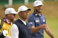 Tiger Woods of the US, and Max Homa of the US, right, arrive to play the first round of the British Open golf championship on the Old Course at St. Andrews, Scotland, Thursday July 14, 2022. The Open Championship returns to the home of golf on July 14-17, 2022, to celebrate the 150th edition of the sport's oldest championship, which dates to 1860 and was first played at St. Andrews in 1873. (AP Photo/Gerald Herbert)