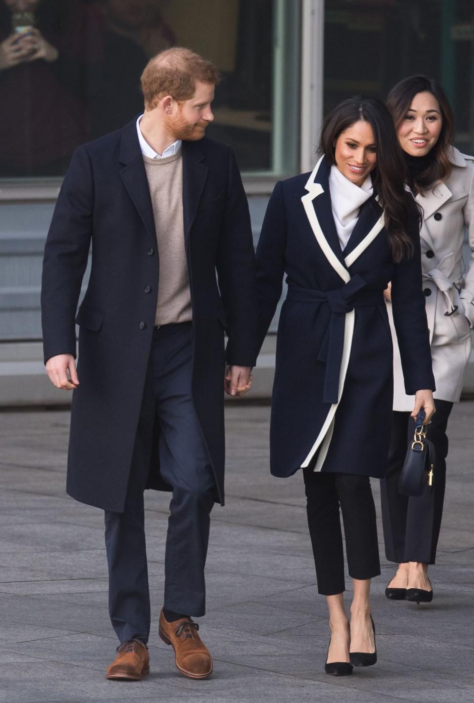 Meghan and Harry hold hands while on a royal visit to Birmingham.