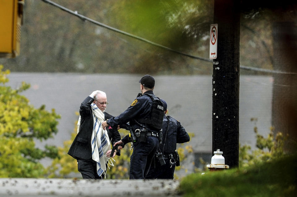 A man is escorted out of the Tree of Life Congregation synagogue by police following a shooting at the Pittsburgh synagogue, Oct. 27, 2018. (Photo: Alexandra Wimley/Pittsburgh Post-Gazette via AP)