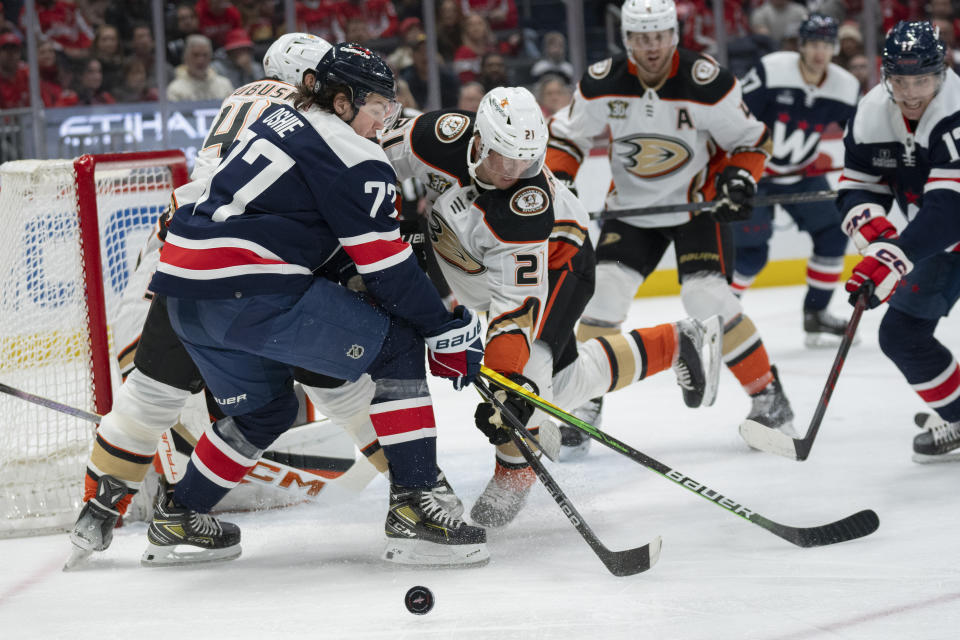 Washington Capitals right wing T.J. Oshie (77) and Anaheim Ducks center Isac Lundestrom (21) vie for the puck during the first period of an NHL hockey game Tuesday, Jan. 16, 2024, in Washington. (AP Photo/Manuel Balce Ceneta)