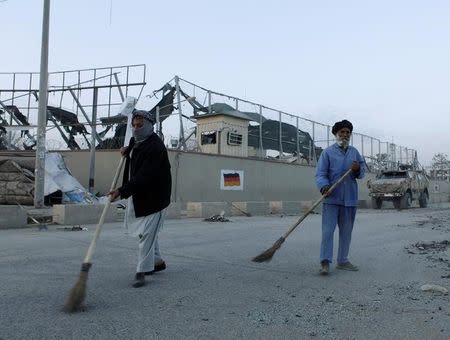 Afghan municipality workers sweep the road in front of the German consulate after a blast in Mazar-i-Sharif, Afghanistan November 11, 2016. REUTERS/Anil Usyan