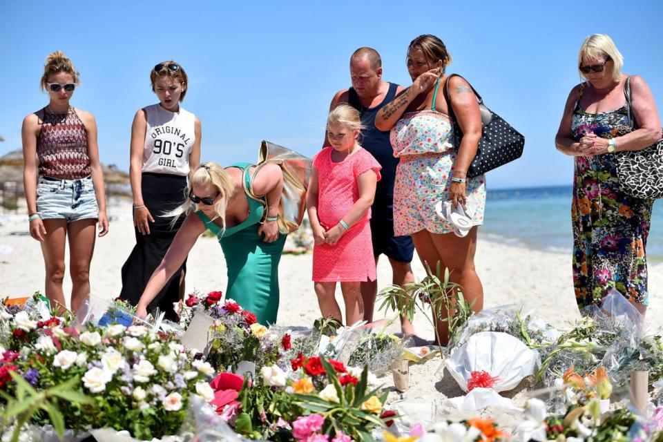 Holidaymakers lay flowers on the beach, where 38 people were killed in a terrorist attack in June 2015. (Jeff J Mitchell/Getty Images)