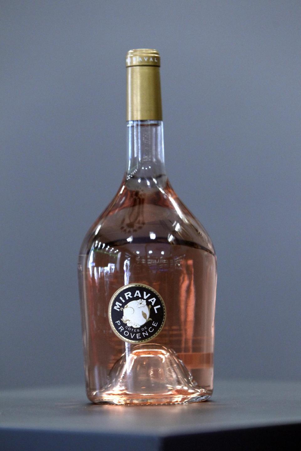 CAPTION CORRECTS NAME OF BOTTLE FROM MIRAMAR TO MIRAVAL A bottle of Miraval 2013 is pictured in Paris, Friday, Jan.31, 2014. The latest Brad Pitt-Angelina Jolie sequel is being described as powerful and elegant with a “mouthwatering finish.” These raves don’t appear in Hollywood bible Variety _ they’re from Decanter magazine’s review of the celebrity couple’s second vintage of rose wine produced at their Provencal estate Chateau Miraval. The 2013 Miraval goes on sale online Friday and will be in shops and restaurants around the world next month. (AP PhotoThibault Camus)