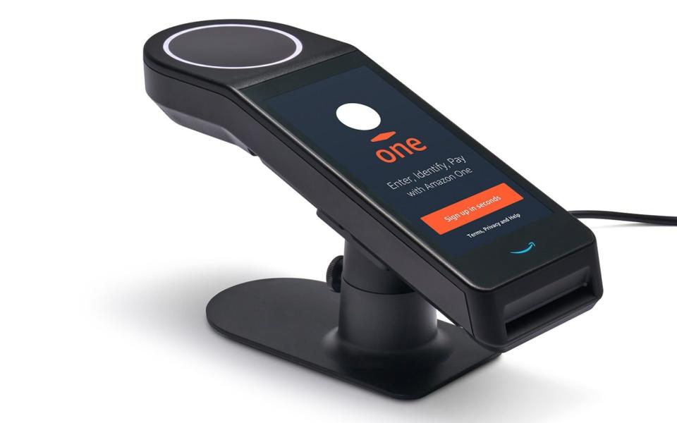 An image released by Amazon of the new palm scanner, which has a smartphone-style screen coupled to a small round pad on the top of the device  - Amazon