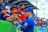 <p>New York Mets player Todd Frazier signs for young fans before the baseball game against the Miami Marlins at First Data Field in Port St. Lucie, Fla., Feb. 25, 2018. (Photo: Gordon Donovan/Yahoo News) </p>