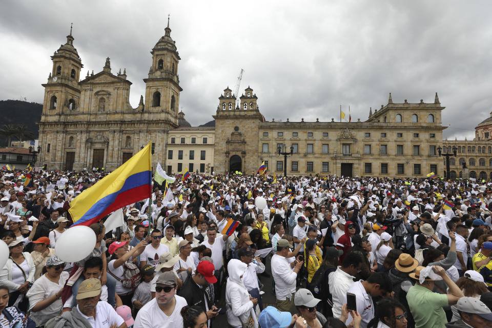 Thousands of people march to repudiate terrorism at the Bolivar square in Bogota, Colombia, Sunday, Jan. 20, 2019. A car bombing at a Bogota police academy that authorities have attributed to rebels of the National Liberation Army killed 21 people and left dozens more wounded on Jan. 17. (AP Photo/Fernando Vergara)