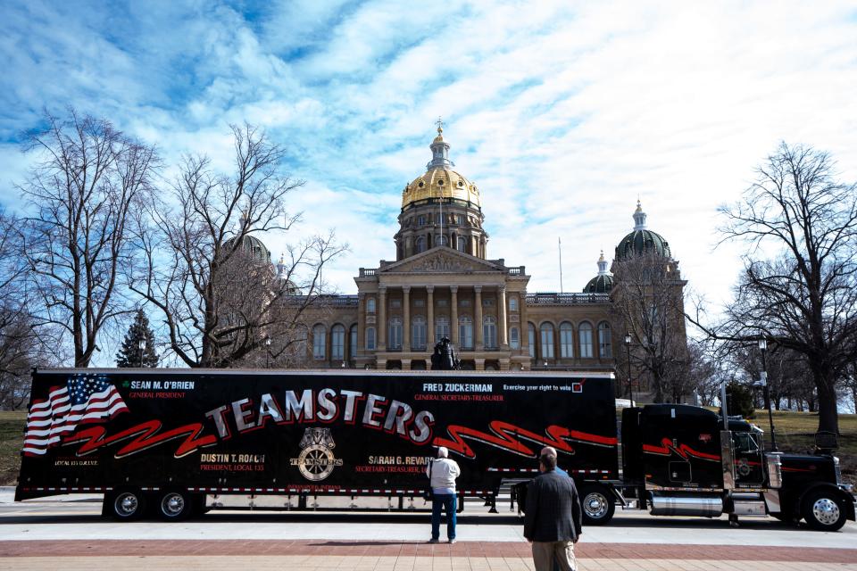 A horn-honking vehicle caravan circles the Iowa Capitol part of a Teamsters Local 238 demonstration Wednesday.