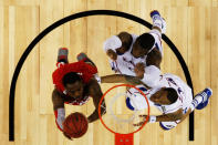 NEW ORLEANS, LA - MARCH 31: Deshaun Thomas #1 of the Ohio State Buckeyes lays the ball up against Thomas Robinson #0 and Travis Releford #24 of the Kansas Jayhawks in the first half during the National Semifinal game of the 2012 NCAA Division I Men's Basketball Championship at the Mercedes-Benz Superdome on March 31, 2012 in New Orleans, Louisiana. (Photo by Ronald Martinez/Getty Images)