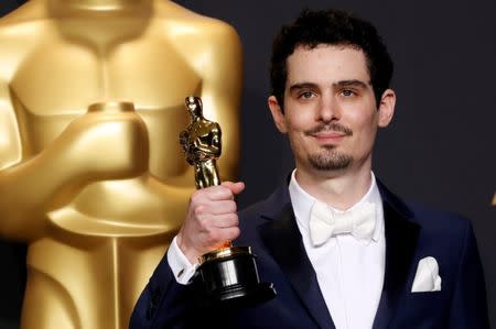 FILE PHOTO: 89th Academy Awards - Oscars Backstage - Hollywood, California, U.S. - 26/02/17 - Damien Chazelle poses with his Oscar for Best Director for the film "La La Land". REUTERS/Lucas Jackson/File Photo