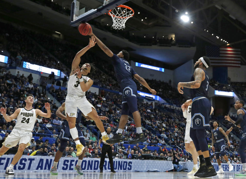 Old Dominion's Kalu Ezikpe (22) blocks a shot by Purdue's Carsen Edwards (3) as Purdue's Grady Eifert (24) and Old Dominion's B.J. Stith (3) look on during the first half of a first-round game in the NCAA men’s college basketball tournament Thursday, March 21, 2019, in Hartford, Conn. (AP Photo/Elise Amendola)