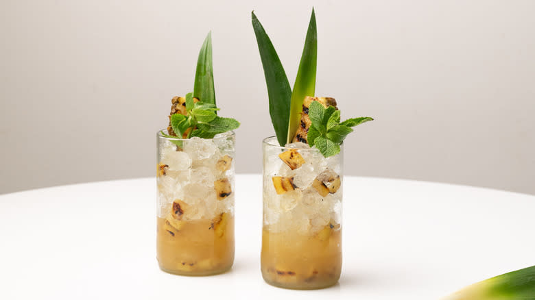 garnishing pineapple mojitos