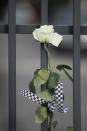 INDIANAPOLIS, IN - OCTOBER 17: A rose hangs on the gate at the Indianapolis Motor Speedway along with other tributes left by fans to two-time Indianapolis 500 winner Dan Wheldon on October 17, 2011 in Indianapolis, Indiana. Wheldon, winner of the 2011 Indy 500, was killed in a crash yesterday at the Izod IndyCar series season finale at Las Vegas Motor Speedway. (Photo by Scott Olson/Getty Images)