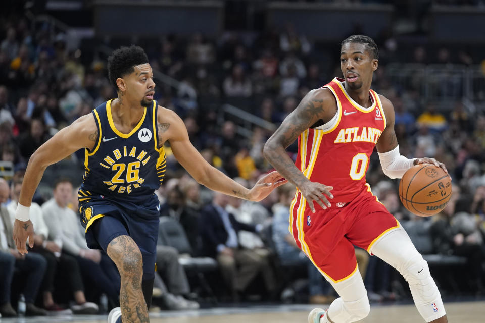 Atlanta Hawks' Delon Wright (0) goes to the basket against Indiana Pacers' Jeremy Lamb (26) during the first half of an NBA basketball game Wednesday, Dec. 1, 2021, in Indianapolis. (AP Photo/Darron Cummings)