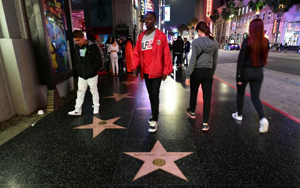 Pedestrians walk by the late Michael Jackson's star on the Hollywood Walk of Fame on June 24, 2019, in Hollywood, Calif.