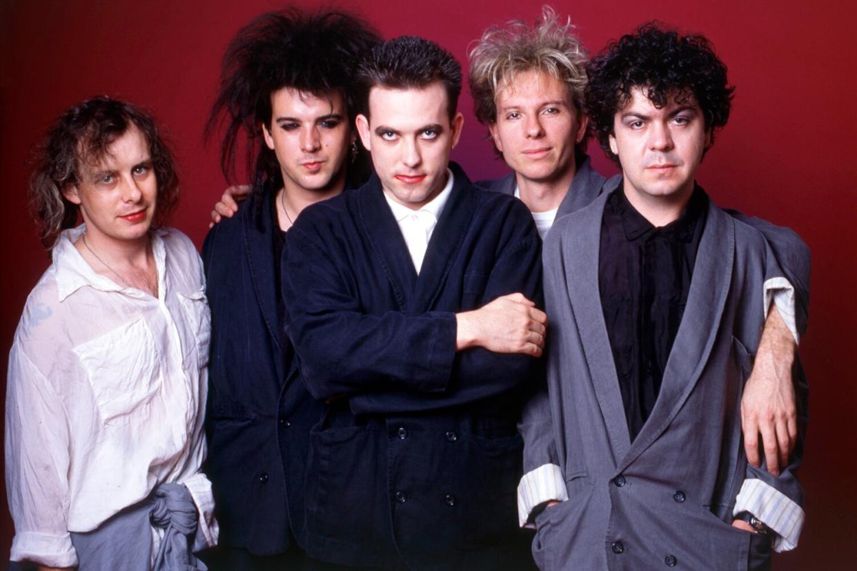 Guitarist Porl Thompson, bass player Simon Gallup, musician, songwriter and lead singer Robert Smith, drummer Boris Williams and keyboard player Laurence 'Lol' Tolhurst, all members of the English rock band The Cure, pose for a portrait backstage at the Pine Knob Music Theatre on July 14, 1986, in Clarkston, Michigan.