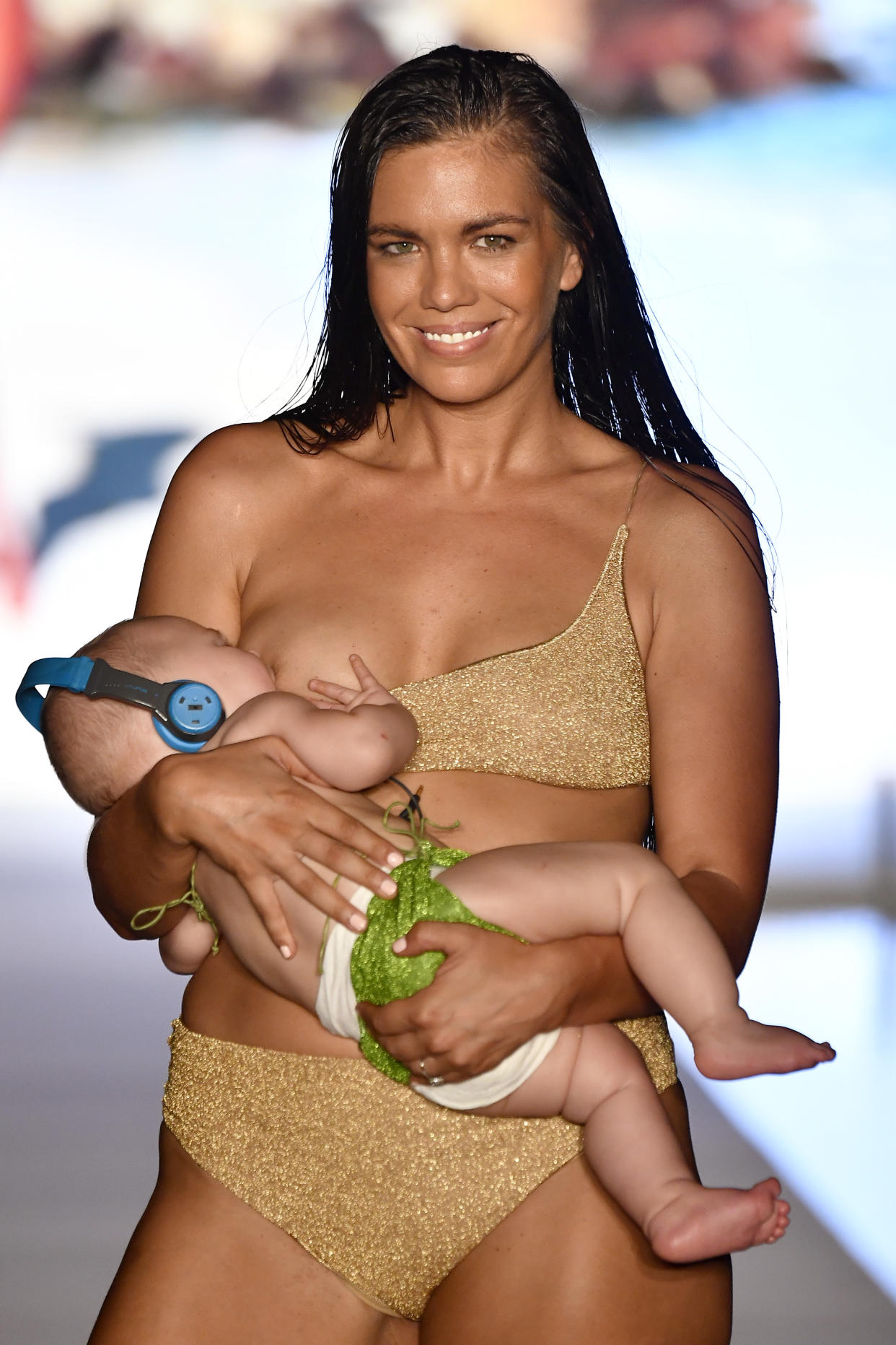 Multitasking Mama! Mara Martin hits the catwalk while breastfeeding her 5-month-old baby [Photo: Sports Illustrated for Getty]