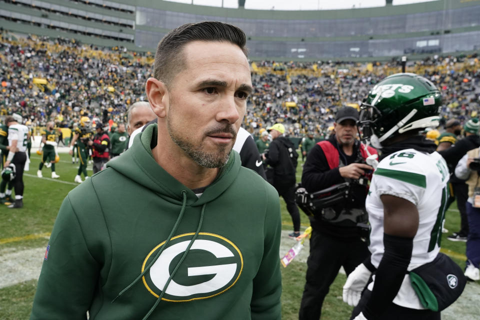 Green Bay Packers head coach Matt LaFleur, center, walks off the field after meeting with New York Jets head coach Robert Saleh after an NFL football game Sunday, Oct. 16, 2022, in Green Bay, Wis. (AP Photo/Morry Gash)