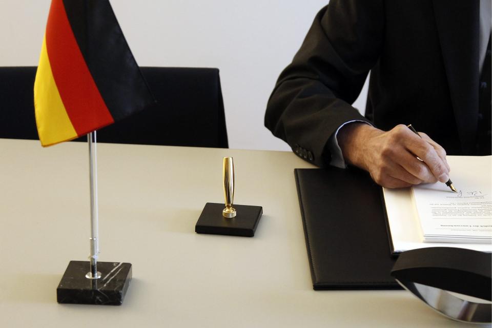 Peter Gottwald, German ambassador in Switzerland, unseen, and Michael Ambuehl, Switzerland's State Secretary for International Financial and Tax Matters, sign an additional protocol on a tax agreement between Germany and Switzerland in Bern, Switzerland, Thursday, April 5, 2012. (AP Photo/Keystone/Peter Klaunzer)