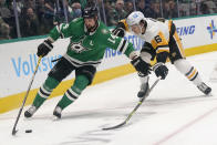 Dallas Stars left wing Jamie Benn (14) skates with the puck against Pittsburgh Penguins defenseman John Marino (6) during the first period of an NHL hockey game in Dallas, Saturday, Jan. 8, 2022. (AP Photo/LM Otero)