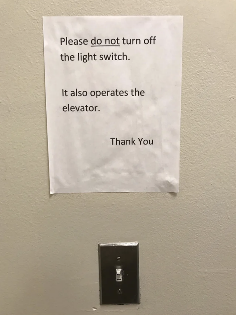 A sign above a normal-looking light switch says "please do not turn off the light switch, it also operates the elevator"