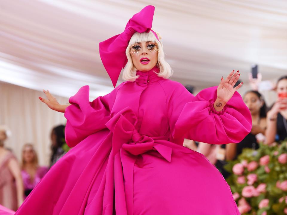 lady gaga attends the met gala in 2019 wearing pink ballgown and headpiece