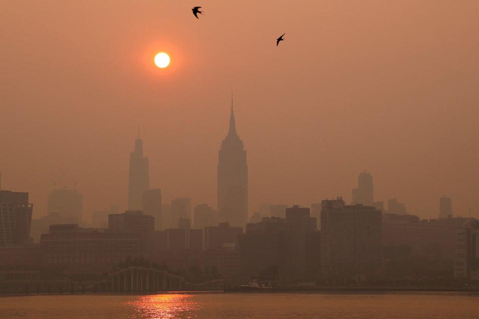 <p>Gary Hershorn/Getty</p> New York City under a blanket of wildfire smoke