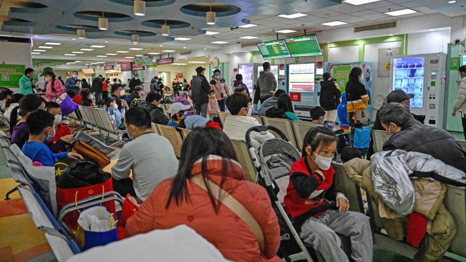 Children and their parents wait at an outpatient area at a children hospital in Beijing (AFP via Getty)