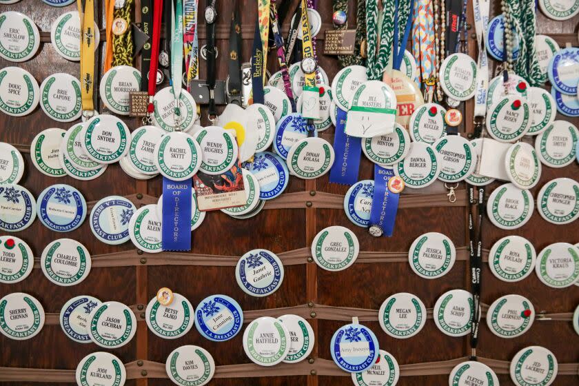 Name tag medallions hanging on a wall.