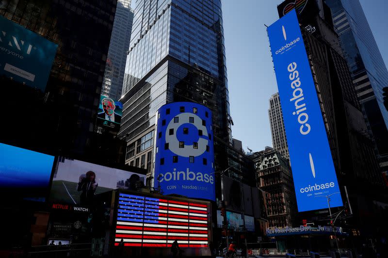 FILE PHOTO: The logo for Coinbase Global Inc, the biggest U.S. cryptocurrency exchange, is displayed on the Nasdaq MarketSite jumbotron and others at Times Square in New York, U.S., April 14, 2021. REUTERS/Shannon Stapleton/