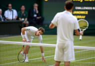 Great Britain's Andy Murray picks himself up after diving to reach the ball in his match against Poland's Jerzy Janowicz during day eleven of the Wimbledon Championships at The All England Lawn Tennis and Croquet Club, Wimbledon.