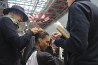 A model is made up backstage to the Elie Saab Haute Couture Spring/Summer 2020 fashion collection presented Wednesday Jan. 22, 2020 in Paris. (AP Photo/Michel Euler)