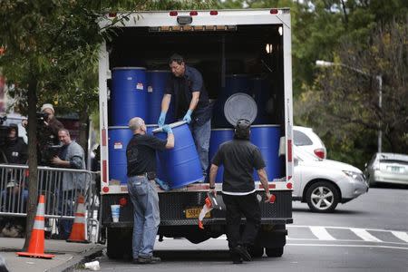 Cleaning crews with "Bio Recovery Corporation" prepare to work at the building where Dr. Craig Spencer lives in New York October 24, 2014. REUTERS/Brendan McDermid