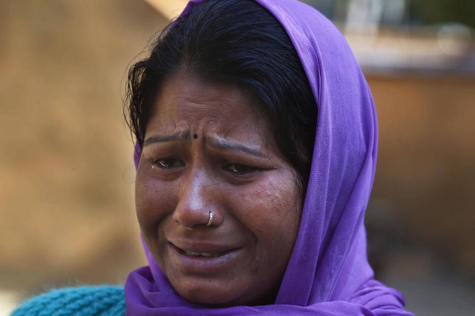 In this Wednesday, Feb. 12, 2014 photo, Sandhya Sharma cries as she relates how her husband was killed recently by a tiger at Kalagarh, in northern India. The tiger stalking the villages of northern India has killed at least nine people so far traveling over 120 miles of villages, small towns and even a highway, spreading fear amongst the villagers many of whom are either farmers or laborers working the the large swathes of sugarcane fields which need harvesting now. (AP Photo/Saurabh Das)