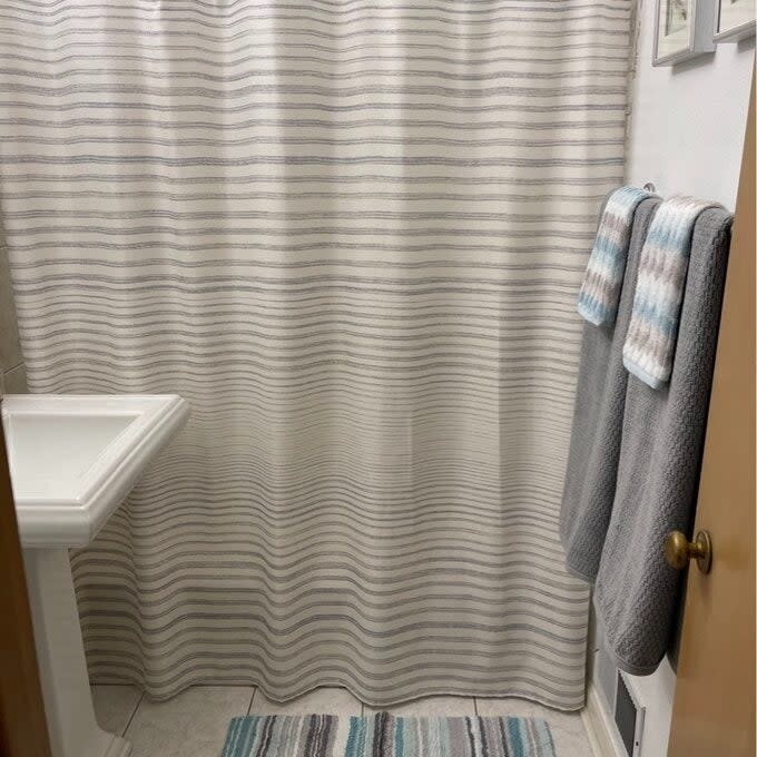 the striped shower curtain in a bathroom