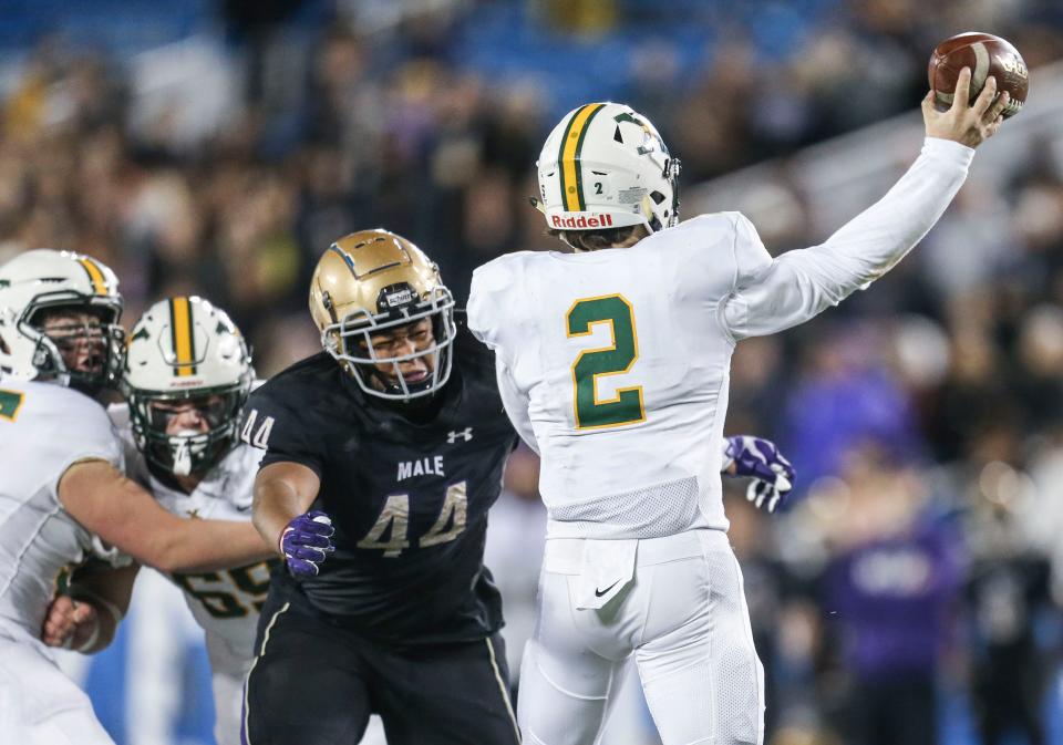 St. X's Jack Sivori was under pressure for much of the game as Male's Selah Brown rushed him in the 6A KHSAA football championship Saturday. Dec.3, 2021 