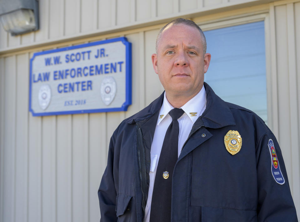 Marion Police Chief John Clair poses outside the Marion Police Department building, Monday, Feb. 5, 2024, in Marion, Va. Clair, chief of the small Appalachian town, spends his days consumed by a growing problem: the frequency with which his officers are tapped to detain, transport and wait in hospitals with people in the throes of a mental health crisis. (AP Photo/Earl Neikirk)