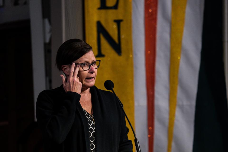 One Iowa board member Jenny Smith wipes her eyes while speaking during a celebration of life service for Sharon Malheiro on Saturday, April 15, 2023, at Plymouth United Church of Christ in Des Moines, Iowa.