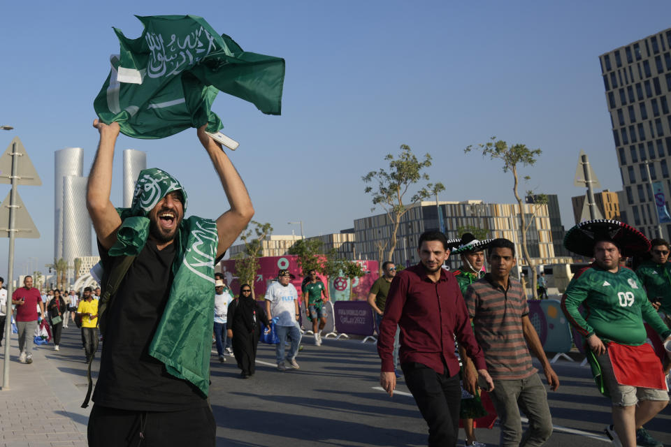 A fan of Saudi Arabia celebrates his team 2-1 victory over Argentina in a World Cup group C soccer match, outside the Lusail Stadium in Lusail Qatar, Tuesday, Nov. 22, 2022. (AP Photo/Andre Penner)