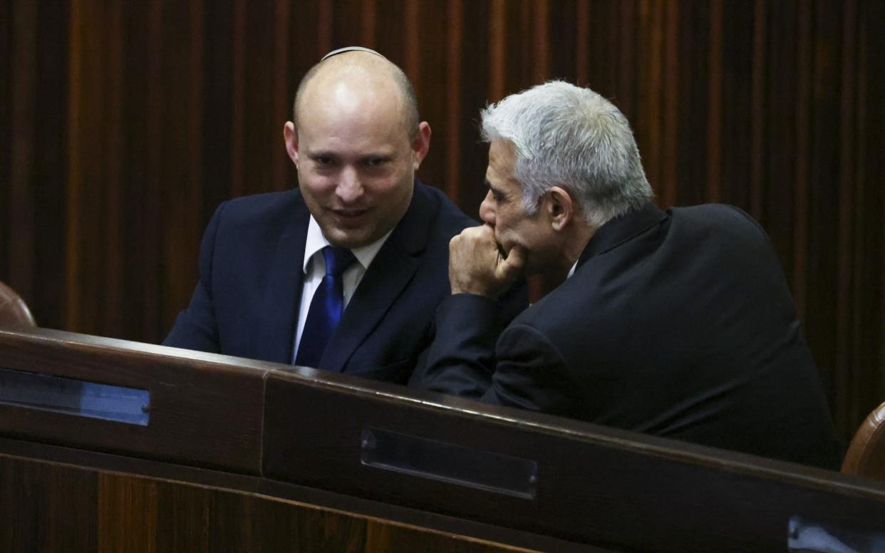 Under the deal, Naftali Bennett, left, will be prime minister for two years before handing over to Yair Lapid - EPA