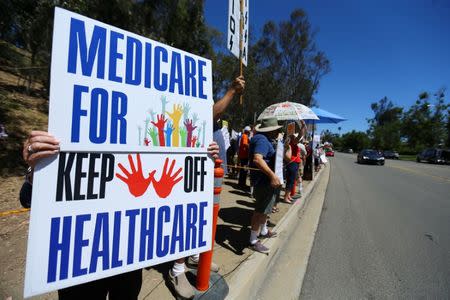 Protesters demonstrate the Republican healthcare bill outside Republican Congressman Darrell Issa's office in Vista, California, June 27, 2017. REUTERS/Mike Blake