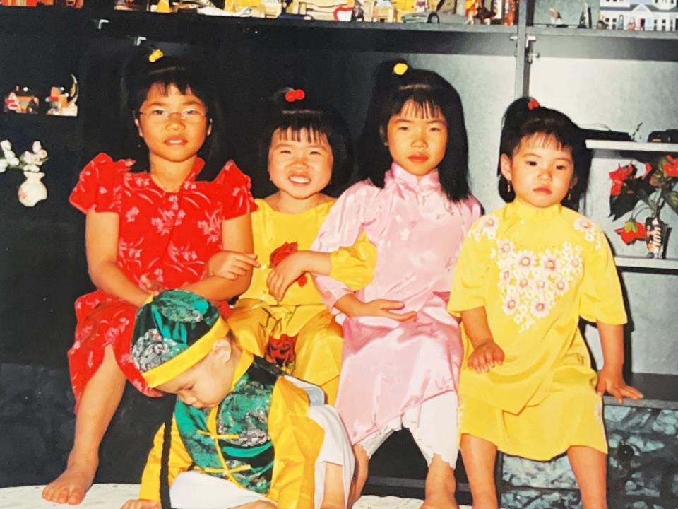 A picture of the siblings in traditional Vietnamese-Chinese dress.