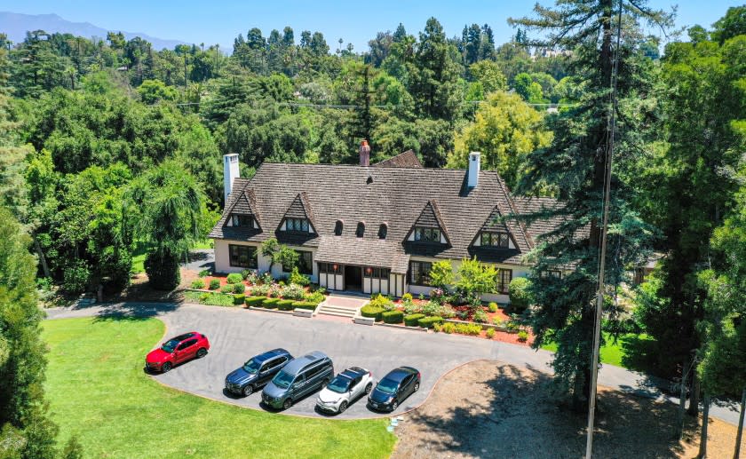 The 3.5-acre spread include a swimming pool, tennis court, rose garden and an English Country home built in 1915.