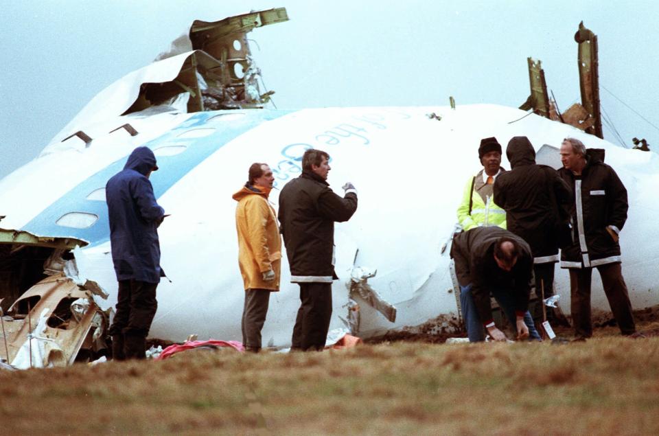 FILE - Unidentified crash investigators inspect the nose section of the crashed Pan Am flight 103, a Boeing 747 airliner in a field near Lockerbie, Scotland, Dec. 23, 1988. The plane crashed two days before, killing more than 270 people. Caulkin, a retired Associated Press photographer has died. He was 77 and suffered from cancer. Known for being in the right place at the right time with the right lens, the London-based Caulkin covered everything from the conflict in Northern Ireland to the Rolling Stones and Britain’s royal family during a career that spanned four decades. (AP Photo/Dave Caulkin, File)