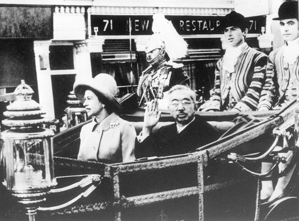 In this Oct. 5, 1971, photo, Emperor Hirohito, center right, and Queen Elizabeth II, center left, are in carriage on their way to the Buckingham Palace as part of his tour to Europe. The Japanese Emperor Akihito’s expression of “deep remorse” for World War II is in keeping with what by all appearances has become his mission: to make amends for a war fought in the name of his father, Hirohito. For the last time in his 30-year reign, Emperor Akihito addressed an annual memorial service Wednesday, Aug. 15, 2018, marking the end of World War II. (Kyodo News via AP)