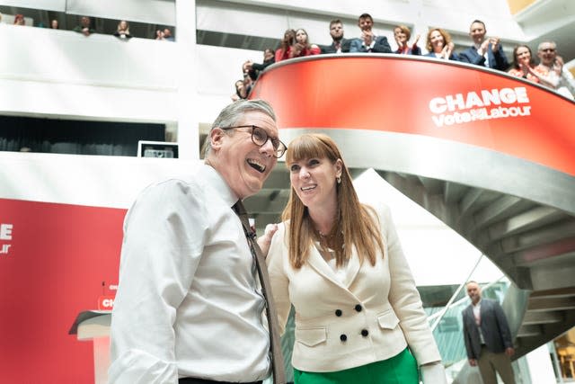 Sir Keir Starmer and Angela Rayner share a joke as they receive applause from Labour supporters