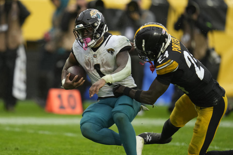 Jacksonville Jaguars running back Travis Etienne Jr. (1) scores past Pittsburgh Steelers cornerback Joey Porter Jr. (24) on a 456-yard touchdown reception during the second half of an NFL football game Sunday, Oct. 29, 2023, in Pittsburgh. (AP Photo/Gene J. Puskar)