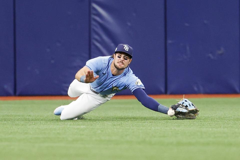 Tampa Bay Rays center fielder Josh Lowe misses a catch off Boston Red Sox designated hitter Justin Turner during the fifth inning of a baseball game in St. Petersburg, Fla., Thursday, April 13, 2023. (Ivy Ceballo/Tampa Bay Times via AP)