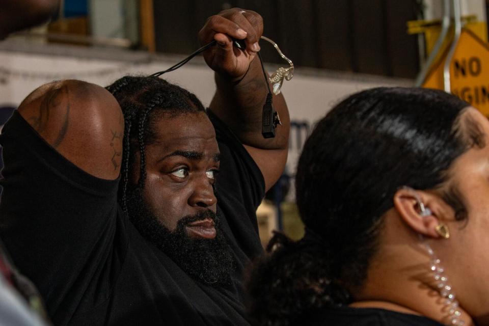 David, left, 38, learns to use earpieces and walkie-talkies during a ManifestWorks workshop.