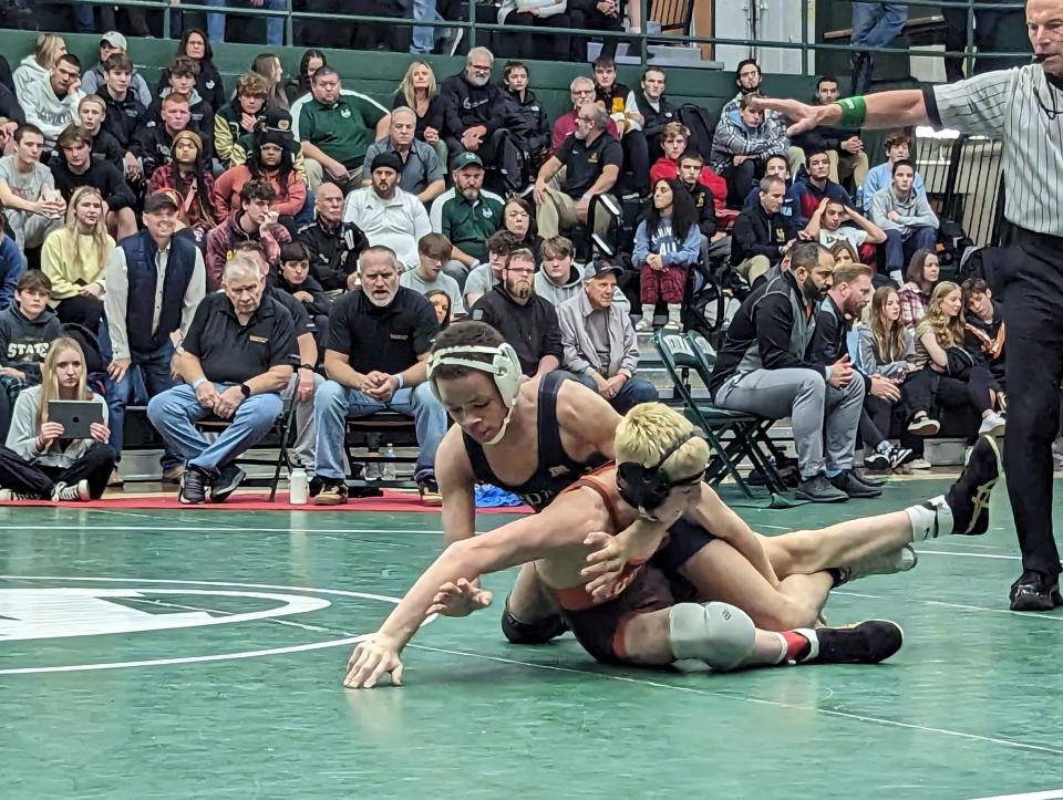 Copley's Javaan Yarbrough scores on Buckeye's Blake Bartos during his 106-pound championship win at the Medina Invitational Tournament on Thursday, Dec. 29, 2022.